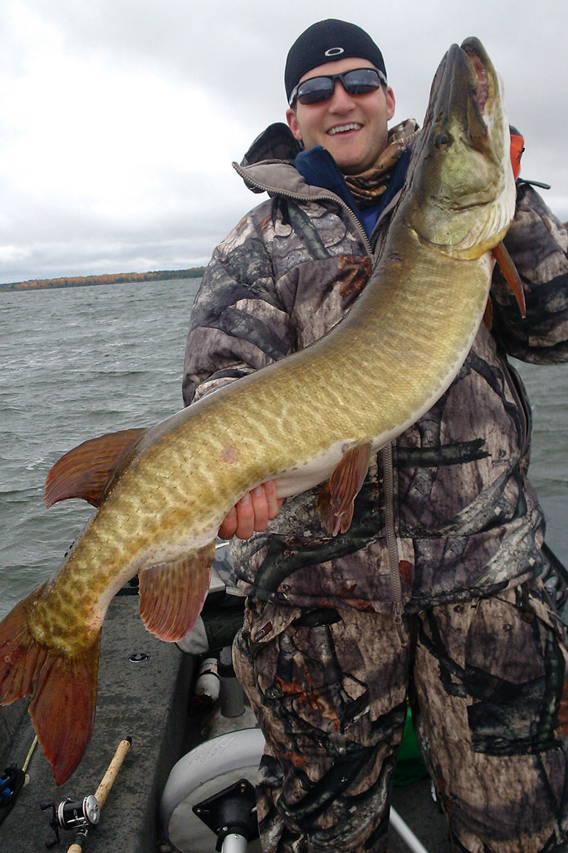 Corey Henne holding musky caught on Lac Vieux Desert